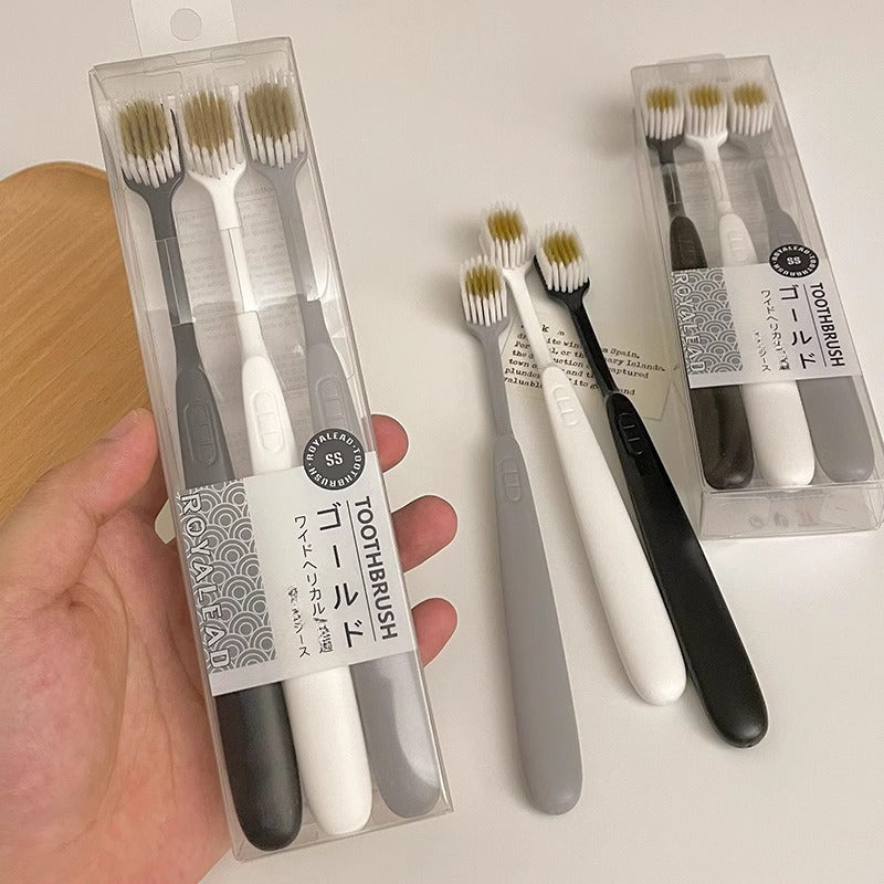 Set of Three Ultra-Soft Bristle Toothbrushes with a Wide Head, Ideal for Adult Use. The Design Helps in Effectively Eliminating Plaque While Being Gentle on Sensitive Teeth And Gums. Offered in Black, White, And Gray Colors with an Ergonomic Handle