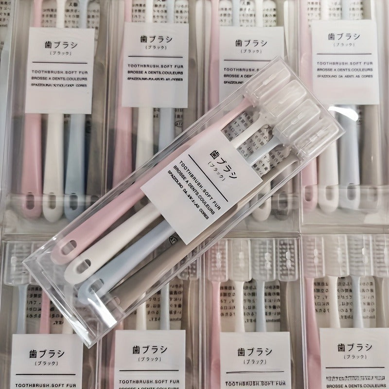 Set of Four Japanese Toothbrushes Featuring Soft Bristles And Protective Cases, Designed for Easy Travel. They Are Gentle on Sensitive Teeth And Gums, Available in Pink, Blue, White, And Beige
