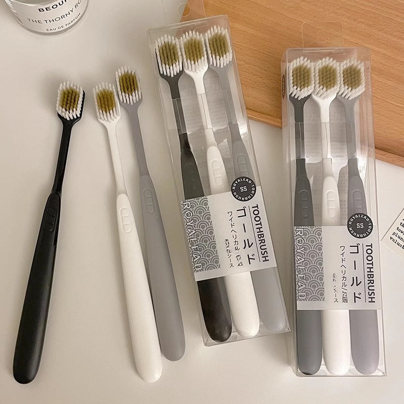 Set of Three Ultra-Soft Bristle Toothbrushes with a Wide Head, Ideal for Adult Use. The Design Helps in Effectively Eliminating Plaque While Being Gentle on Sensitive Teeth And Gums. Offered in Black, White, And Gray Colors with an Ergonomic Handle