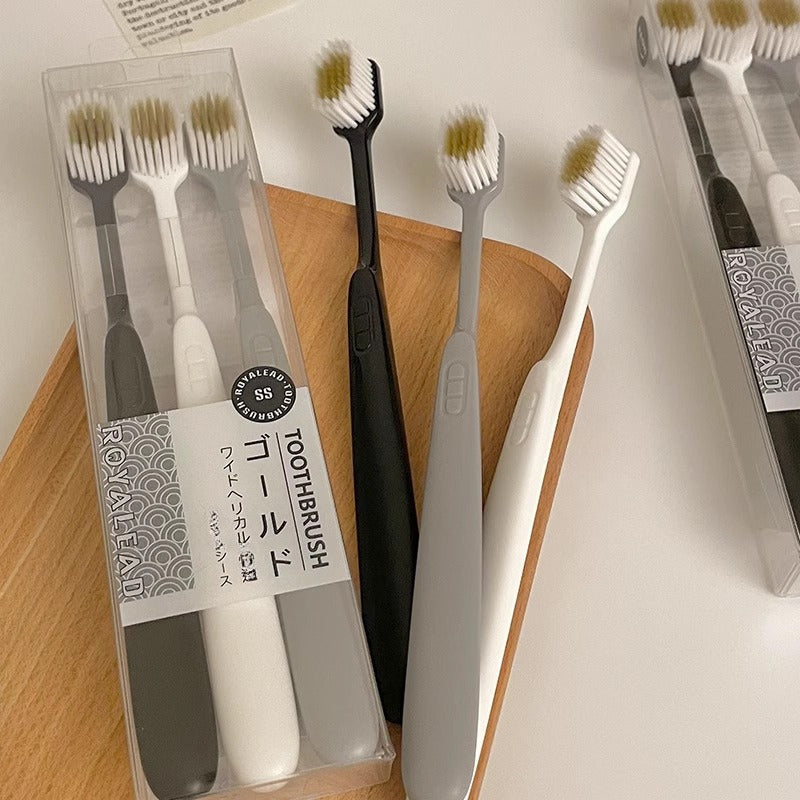 Set of Three Ultra-Soft Bristle Toothbrushes with a Wide Head, Ideal for Adult Use. The Design Helps in Effectively Eliminating Plaque While Being Gentle on Sensitive Teeth And Gums. Offered in Black, White, And Gray Colors with an Ergonomic Handle